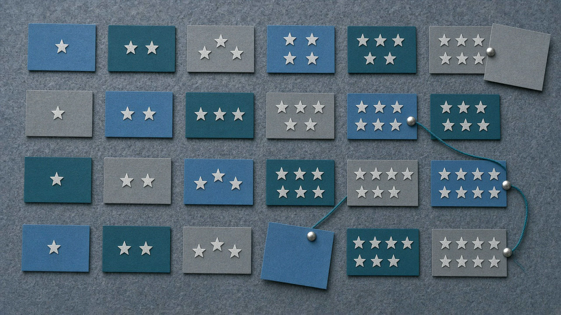 Corkboard of blank cards with one to six gold stars, some flipped over as solved