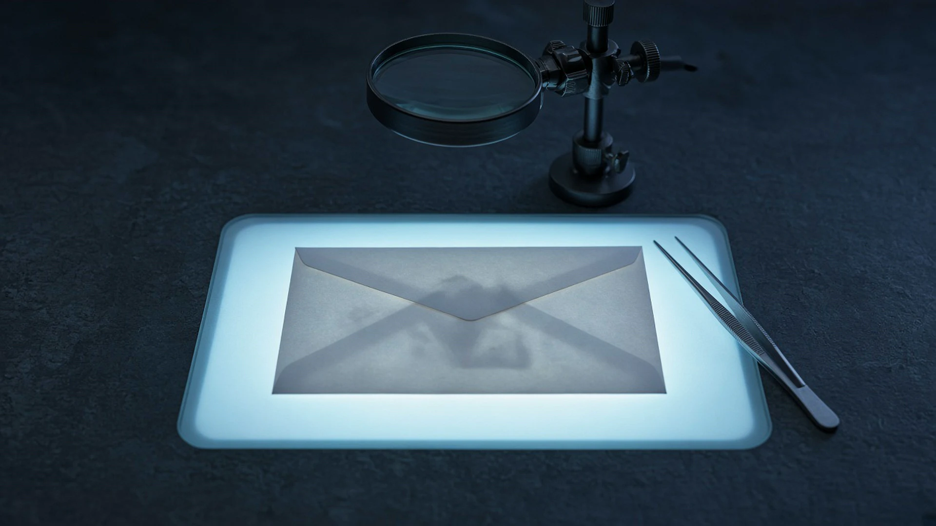 Sealed envelope on a light table examined with a magnifying glass and tweezers